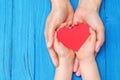 Child and dad hands holding red heart Royalty Free Stock Photo
