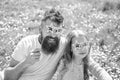 Child and dad posing with star shaped eyeglases photo booth attribute at meadow. Father and daughter sits on grass at Royalty Free Stock Photo