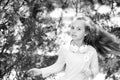 Child dance to music in summer park. Small girl enjoy music in headphones outdoor. Kid dancer with long flying hair Royalty Free Stock Photo