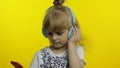 Child dances with smartphone, listening to music on headphones. Little kid girl dancing, having hun Royalty Free Stock Photo