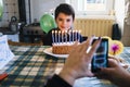 Child in the day of his ninth birthday blowing the candles on th