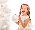 Child decorate Christmas tree.