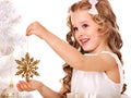 Child decorate Christmas tree.