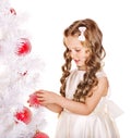 Child decorate Christmas tree.