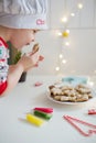 Child decorates Christmas cookies Royalty Free Stock Photo