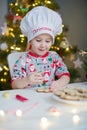 Child decorates Christmas cookies Royalty Free Stock Photo
