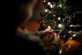 Child decorates the Christmas tree