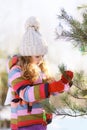 Child decorates a Christmas tree