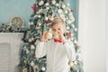 Child decorating Christmas tree at home. Boy hangs Christmas balls on tree. Christmas Eve concept Royalty Free Stock Photo