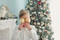 Child decorating Christmas tree at home. Boy hangs Christmas balls on tree. Christmas Eve concept Royalty Free Stock Photo