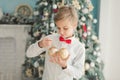 Child decorating Christmas tree at home. Boy hangs Christmas balls on tree. Christmas Eve concept Royalty Free Stock Photo