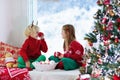 Kids decorate Christmas tree. Child on Xmas eve. Royalty Free Stock Photo