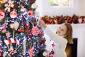 Child decorating Christmas tree. Kid on Xmas eve Royalty Free Stock Photo