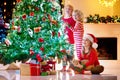 Child decorating Christmas tree. Kid on Xmas eve Royalty Free Stock Photo