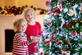 Child decorating Christmas tree. Kid on Xmas eve Royalty Free Stock Photo