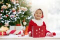 Child decorating Christmas tree. Kid on Xmas eve Royalty Free Stock Photo