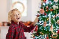 Child decorating Christmas tree. Kid on Xmas eve Royalty Free Stock Photo