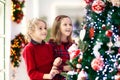 Child decorating Christmas tree. Kid on Xmas eve Royalty Free Stock Photo