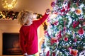 Child decorating Christmas tree. Kid on Xmas eve Royalty Free Stock Photo