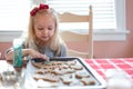 Child decorating cookies with colored sugar sprinkles - holiday traditions Royalty Free Stock Photo