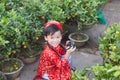 Child with digital compact camera outdoors. Cute little Vietnamese boy in ao dai dress smiling. Tet holiday Royalty Free Stock Photo