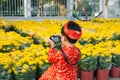 Child with digital compact camera outdoors. Cute little Vietnamese boy in ao dai dress. Tet holiday Royalty Free Stock Photo