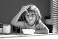 Child dinner. Portrait of fun kid having healthy tasty snack. Small kid crazy posing by kitchen table.