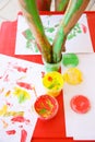 Child dipping fingers in washable finger paints