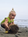 Child with dirty face and hands playing with coconut Royalty Free Stock Photo