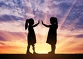 The child is a disabled girl with a prosthetic leg and her friend in the open air at sunset Royalty Free Stock Photo