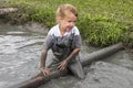 Child in ditch in Mud Race Royalty Free Stock Photo