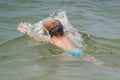 The child dives under the water on the lake. Improving and learning to swim. Healthy lifestyle.