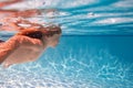 Child dives into the water in swimming pool. little kid swim underwater in pool. Child swimming underwater in sea or