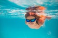 Child dives into the water in swimming pool. little kid swim underwater in pool. Child swimming underwater in sea or