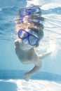 Child diving undwerwater in mask in pool Royalty Free Stock Photo