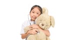 Child in doctor coat using stethoscope examine teddy bear Royalty Free Stock Photo