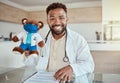 Child doctor, pediatrician and healthcare work holding a teddy bear toy and looking happy and friendly while sitting in Royalty Free Stock Photo