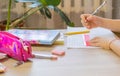 The child does his homework, drawing with a ruler. Selective focus. Royalty Free Stock Photo