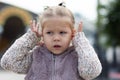 Child does not want to hear anything closing her ears