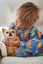 Child, dog and animal playing on couch for bonding together, connection or adoption in living room. Young boy, pet puppy Royalty Free Stock Photo