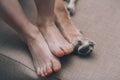Child and dog concept. Baby feet and dog paws closeup. Royalty Free Stock Photo