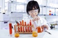 Child doing chemical research in lab