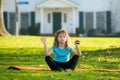 Child doing exercise outdoors. Healthy kids lifestyle. Yoga children in park doing yoga asana. Lifestyle relaxation