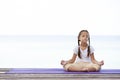 Child doing exercise on platform outdoors. Healthy lifestyle. Yoga girl Royalty Free Stock Photo