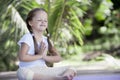 Child doing exercise on platform outdoors. Healthy lifestyle. Yoga girl Royalty Free Stock Photo