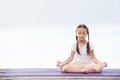 Child doing exercise on platform outdoors. Healthy lifestyle. Yoga girl Royalty Free Stock Photo