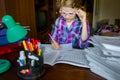 Child doing homework in glasses for improving vision