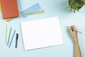 Child doing homework. Top view to desk with open blank notebook, books, colored overlay strips for Dyslexia students Royalty Free Stock Photo