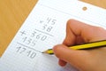 Child doing a math multiplication at school. Royalty Free Stock Photo