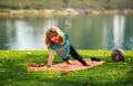 Child doing push-ups exercise outdoors. Healthy kids lifestyle. Children pushing up in park. Lifestyle relaxation Royalty Free Stock Photo